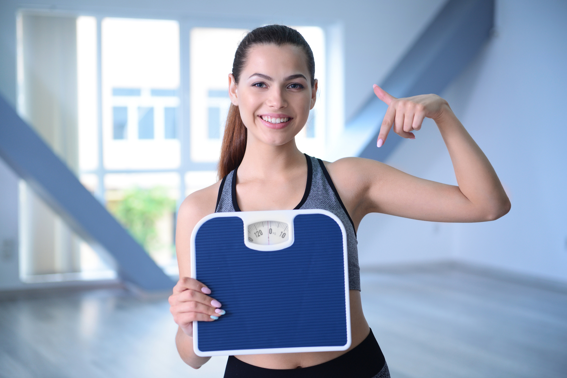 Young Woman with Weighing Scale 